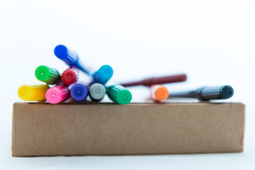 Many colorful felt tip pens on Brown paper box