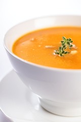 Bowl with pumpkin soup on white background