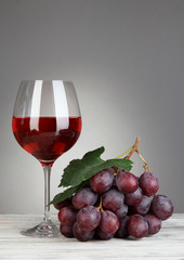 Ripe delicious grapes with glass of wine
