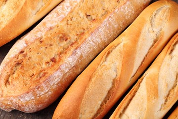 Top view of baguettes on wooden background