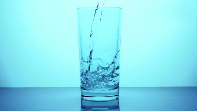 Pouring glass of water in slow motion