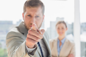 Angry businessman pointing at camera