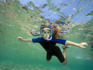 Beautiful healthy girl swims in the sea