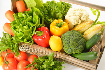 fruits and vegetables in wooden basket on white background
