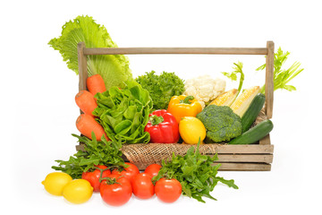 fruits and vegetables in wooden basket on white background