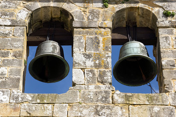 Obraz premium ancient bell tower with bells and blue sky