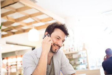 man at the bar on the phone