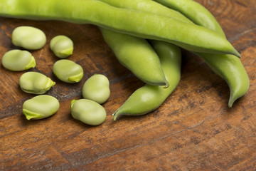 broad beans on wooden background