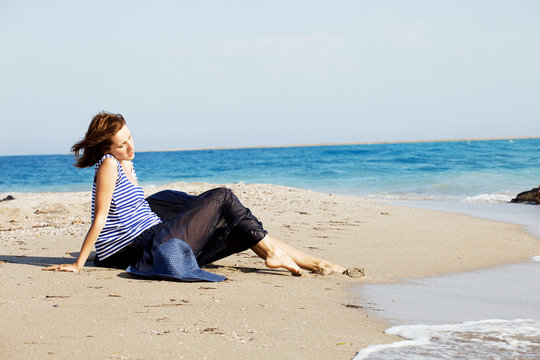 beautiful  tanned woman resting on the beach in summer day