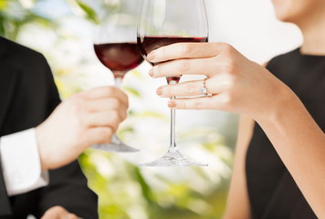 engaged couple with wine glasses