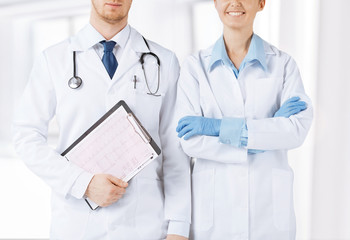 nurse and male doctor holding cardiogram