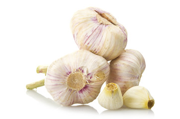 fresh garlic and two garlic cloves on the white