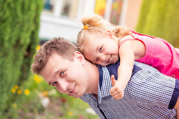 Happy father and daughter playing in the park