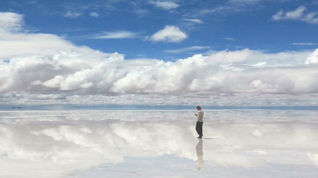 Man talking on the mobile phone on Salar de Uyuni, Bolivia
