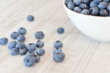 White bowl cup with fresh ripe blueberries