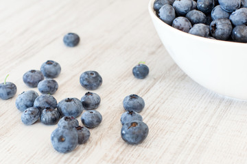 White bowl cup with fresh ripe blueberries