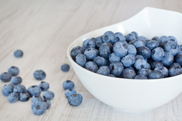 White bowl cup with fresh ripe blueberries