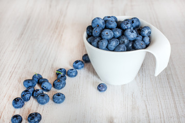 White bowl cup with fresh ripe blueberries