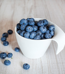 White bowl cup with fresh ripe blueberries
