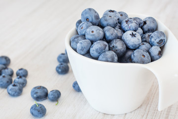 White bowl cup with fresh ripe blueberries