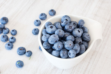 White bowl cup with fresh ripe blueberries