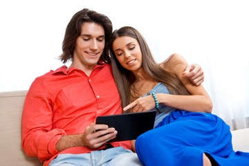 young couple with tablet