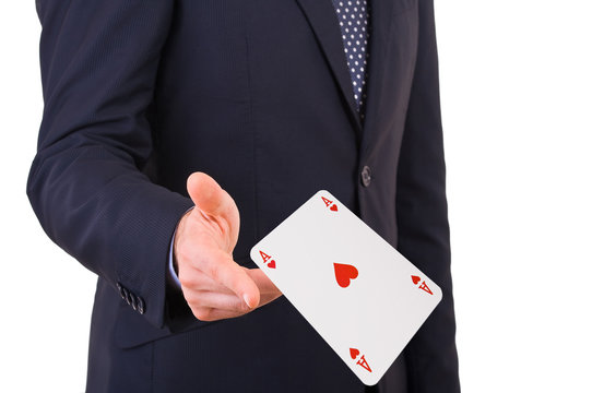 Businessman throwing playing card.
