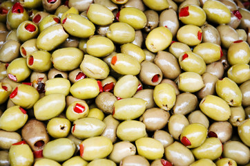 Green olives stuffed with red paprika
