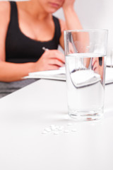 young business woman with water glass on the desk