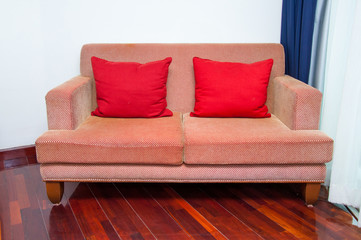sofa with red pillows on white background