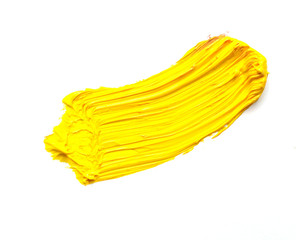yellow stroke of the paint brush isolated on white