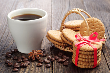 Sweet cookies tied ribbon and cup of coffee