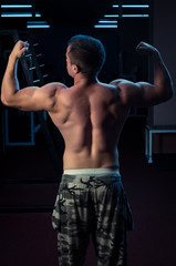 Fototapeta na wymiar Showing muscles in gym