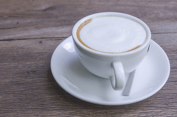 Obraz na płótnie Canvas cappuccino coffee on wooden table