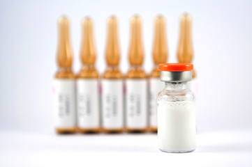 Orange cap injection vials on brown ampule