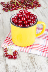 Sweet cherry in cup on table close-up