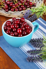 Sweet cherry in cup on table close-up