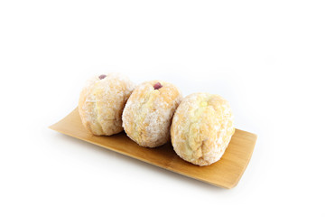 Blueberry donuts on bamboo dish.