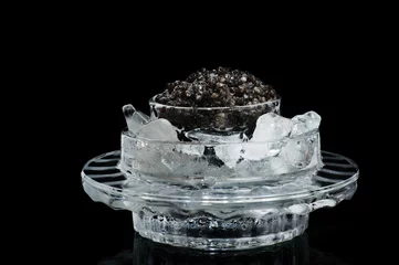 Fotobehang Black caviar in ice on a black © andriikoval