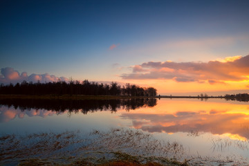 Fototapeta premium calm sunset over lake surface