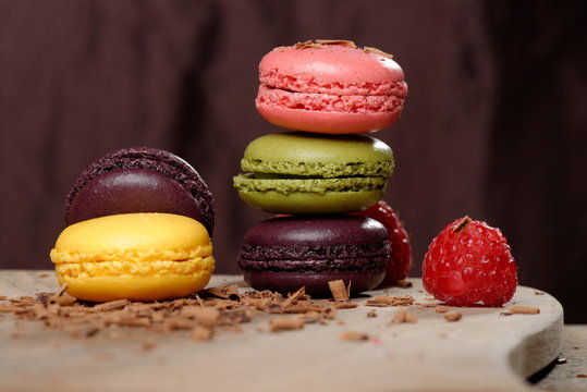 Colorful macaroons and fresh raspberries