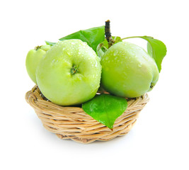 Fresh green apples are in a little basket on a white background