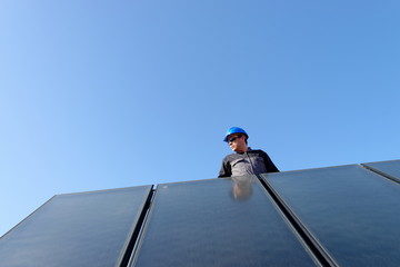 Man installing alternative energy photovoltaic solar panels
