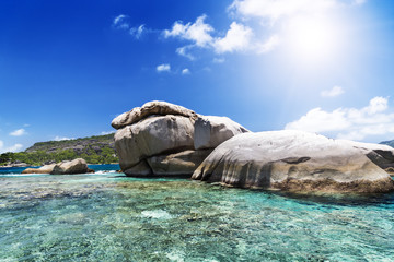 Big rock on sunny beach. Seychelles island.