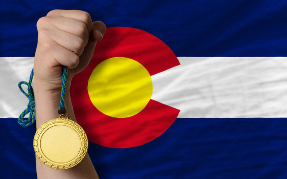 Gold medal for sport and flag of american state of colorado