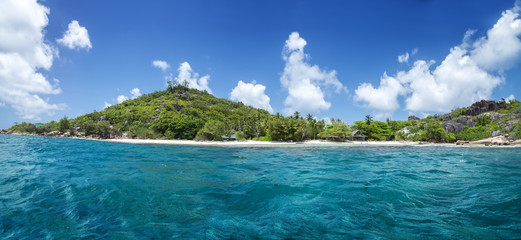 White coral sand on tropical beach. La Digue island, Seyshelles.