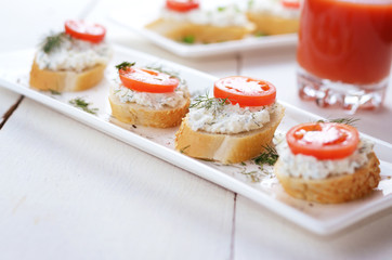 Breakfast of cottage cheese bruschettas and tomato juice