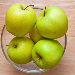 Green apples in a glass bowl