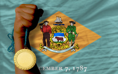 Gold medal for sport and  flag of american state of delaware