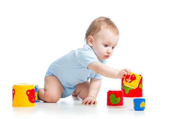 baby boy playing with toys, isolated over white